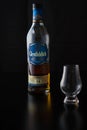A glencairn glass accompanied by a bottle of scotch whisky