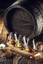 Glencairn tasting whiskey cups with wooden barrel, peat and barley next to them Royalty Free Stock Photo