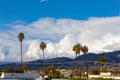 Glendale building, homes and hillside leading to san gabriel mountains, with blue sky and towering clouds