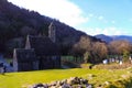 GLENDALOUGH, IRELAND - February 19 2018: St. Kevin`s monastic city at Glendalough famed for its rounds towers, and Celtic crosses Royalty Free Stock Photo