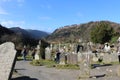 GLENDALOUGH, IRELAND - February 20 2018: The ancient cemetery in monastic site Glendalough. Glendalough Valley, Wicklow Mountains Royalty Free Stock Photo