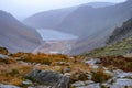 Glendalough Upper lake from miners way, Glenealo valley, Wicklow way, County Wicklow, Ireland. Autumn hike during foggy weather an Royalty Free Stock Photo