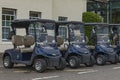 Blue golf buggies parked up in a row at the golf course Royalty Free Stock Photo
