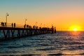 Glenelg Beach jetty with people at sunset Royalty Free Stock Photo