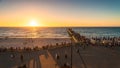 Glenelg Beach jetty with people walking along at sunset