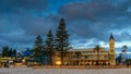 Glenelg Town Hall with people around at sunset