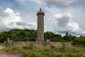 Glenfinnan Monument from beginning of the 19th century with a statue of anonymous highlander in Scotland