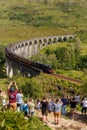 Glenfinnan Viaduct, Scotland, UK - 26 July, 2019: Crowds of tourists photographing Glenfinnan Viaduct