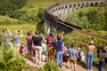 Glenfinnan Viaduct, Scotland, UK - 26 July, 2019: Crowds of tourists photographing Glenfinnan Viaduct
