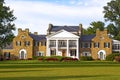 Glenview historic mansion with formal gardens at sunset.