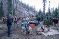 Group of hunters gather at a campsite after an elk hunting trip in the mountains