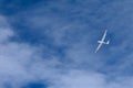 A glider flying across the blue sky