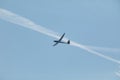 A glider flying in the blue sky ejects the water before the landing. Royalty Free Stock Photo