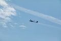 A glider flying in the blue sky ejects the water before the landing. Royalty Free Stock Photo