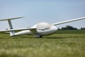 Glider on the grassy airfield. Royalty Free Stock Photo