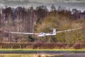 Glider landing across hedgerow Royalty Free Stock Photo