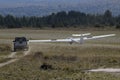 glider landing with van waiting to tow it.