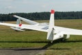 Glider plane standing on grass airport runway, at Pociunu airport, Lithuania Royalty Free Stock Photo
