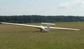 Glider plane standing on grass airport runway, at Pociunu airport, Lithuania Royalty Free Stock Photo