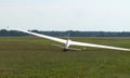 Glider plane standing on grass airport runway, at Pociunu airport, Lithuania Royalty Free Stock Photo