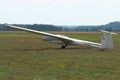 Glider plane standing on grass airport runway, at Pociunu airport, Lithuania Royalty Free Stock Photo