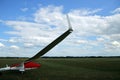 Glider plane standing on grass airport runway, at Pociunu airport, Lithuania Royalty Free Stock Photo