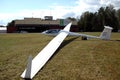 Glider plane standing on grass airport runway, at Pociunu airport, Lithuania Royalty Free Stock Photo