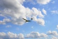 Glider, sailplane flying against blue cloudy sky