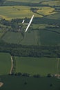 Glider, sailplane flying over countryside. Royalty Free Stock Photo