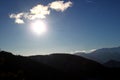 Glider silhouette flying against the blue sky with clouds and sunlight / Austria Royalty Free Stock Photo