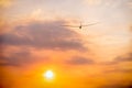 A glider soaring toward the setting sun Royalty Free Stock Photo