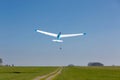 A glider takes off into a clear blue sky