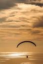 Gliding at sunset hour with sea in the background