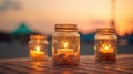 Glimmers of Tranquility: Closeup Macro of Candles in Ornate Glass Jars at Seafront Sunset Royalty Free Stock Photo
