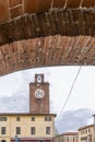 A glimpse of the historic center of Cascina, Pisa, Italy, framed in a covered walkway Royalty Free Stock Photo