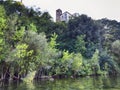 Glimpse near Bracciano lake at Anguillara Sabazia pittoresque village shore with transparent water and lush greenery and partial