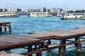 Glimpse of the port of MalÃÂ¨ in Maldives and skyline city, with wooden pier and numerous boats used for transport and tourist