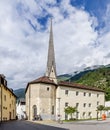 A glimpse of Silandro, South Tyrol, Italy, with the Spitalkirche church and in the background the mountains