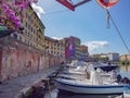 Glimpse of a Typical Livorno neighborhood in Tuscany with Venice-style waterways and Small Motor Boats Moored along the Sides,