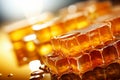 Glistening honey filled honeycombs in close up view, reflecting light on smooth surfaces