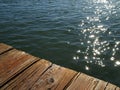 Glistening water beneath old wooden dock