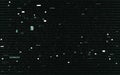 Glitch elements on black backdrop. Abstract green pixels and shapes. White noise and lines. Digital video distortion. No