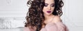 Glitter beauty makeup. Brunette with curly hair style wears in p