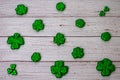 Glitter Covered Four Leaf Clovers in a Pattern on a White Wood Background Royalty Free Stock Photo
