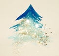 Glitter and glittering stars on abstract blue watercolor Christmas tree in vintage nostalgic colors.