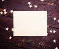Glitter golden stars with blank paper on grunge wood Royalty Free Stock Photo