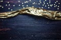 Glitter golden stars and golden ribbon on grunge wood Royalty Free Stock Photo