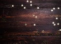 Glitter golden stars on grunge wood background. Royalty Free Stock Photo