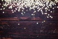 Glitter golden stars on grunge wood background. Royalty Free Stock Photo