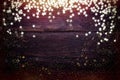 Glitter golden stars on grunge wood background. Royalty Free Stock Photo